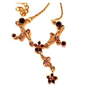 Gold tone purple flower stone necklace